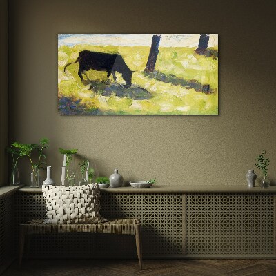 Tableau sur verre Une vache broutant dans un paysage verdoyant
