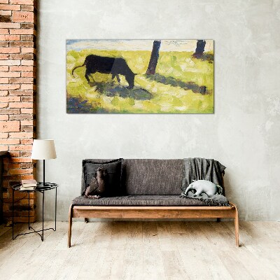 Tableau sur verre Une vache broutant dans un paysage verdoyant