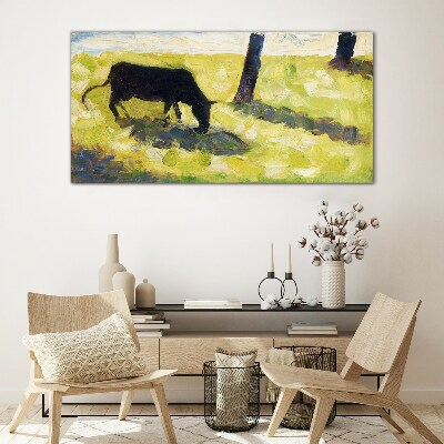 Tableau sur verre Une vache broutant dans un paysage verdoyant