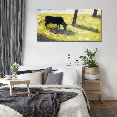 Tableau sur verre Une vache broutant dans un paysage verdoyant