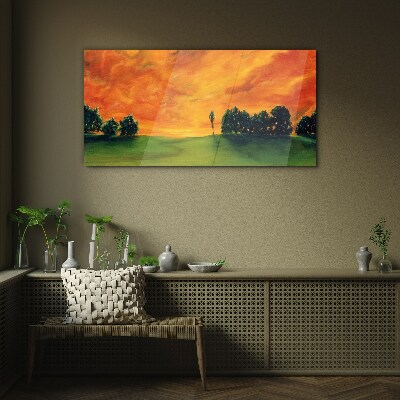Tableau imprimé sur verre Coucher de soleil sur une colline verdoyante
