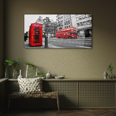 Tableau verre imprimé Un téléphone rouge dans une ville grise