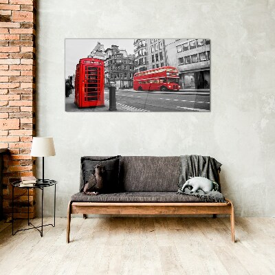 Tableau verre imprimé Un téléphone rouge dans une ville grise