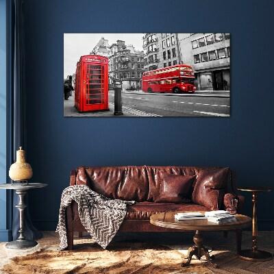 Tableau verre imprimé Un téléphone rouge dans une ville grise