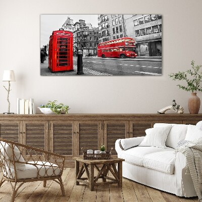 Tableau verre imprimé Un téléphone rouge dans une ville grise