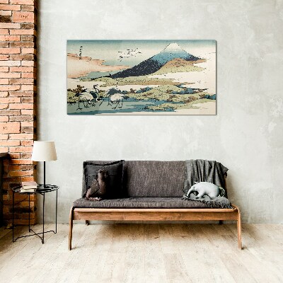 Tableau imprimé sur verre Grues près d'une montagne