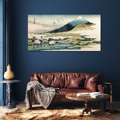 Tableau imprimé sur verre Grues près d'une montagne