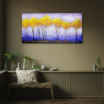 Tableau photo sur verre Des arbres dorés dans un paysage violet