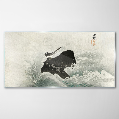 Tableau photo sur verre Un oiseau sur un rocher dans les vagues