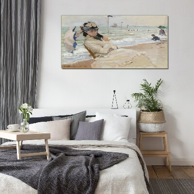 Tableau photo sur verre Femme sur la plage avec un parasol