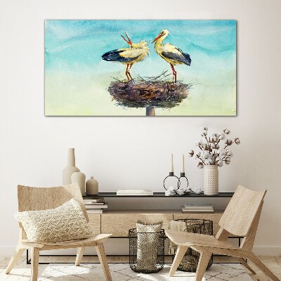 Tableau en verre Cigognes sur un nid dans le bleu