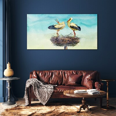 Tableau en verre Cigognes sur un nid dans le bleu