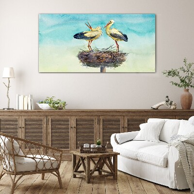 Tableau en verre Cigognes sur un nid dans le bleu