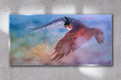 Tableau sur verre Vol d'un oiseau de proie dans les nuages
