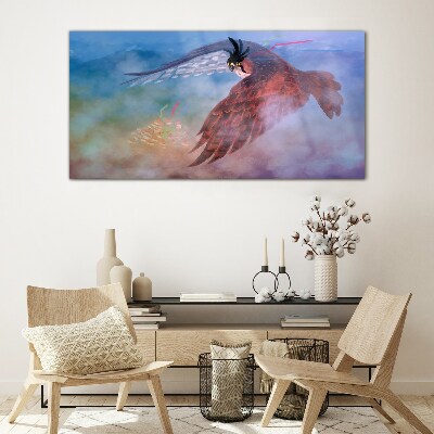 Tableau sur verre Vol d'un oiseau de proie dans les nuages