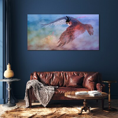 Tableau sur verre Vol d'un oiseau de proie dans les nuages