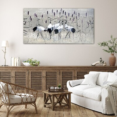 Tableau imprimé sur verre Grues blanches dans les roseaux