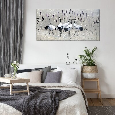 Tableau imprimé sur verre Grues blanches dans les roseaux