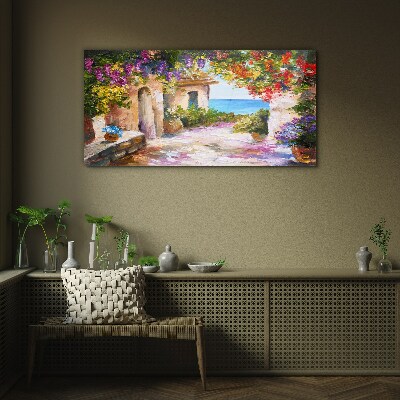 Tableau photo sur verre L'allée fleurie d'un village balnéaire