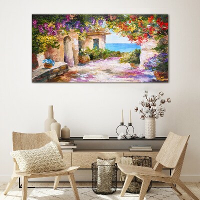 Tableau photo sur verre L'allée fleurie d'un village balnéaire