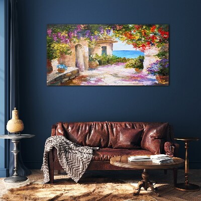 Tableau photo sur verre L'allée fleurie d'un village balnéaire