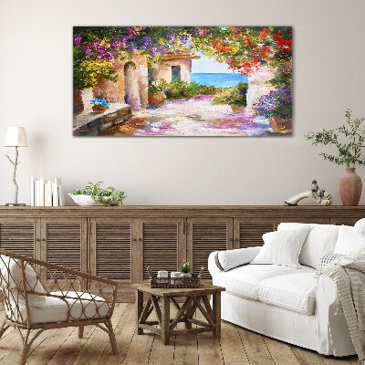 Tableau photo sur verre L'allée fleurie d'un village balnéaire