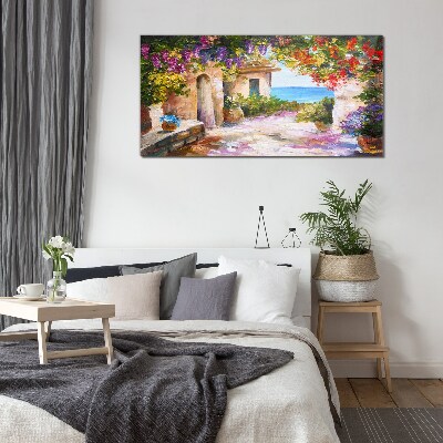 Tableau photo sur verre L'allée fleurie d'un village balnéaire