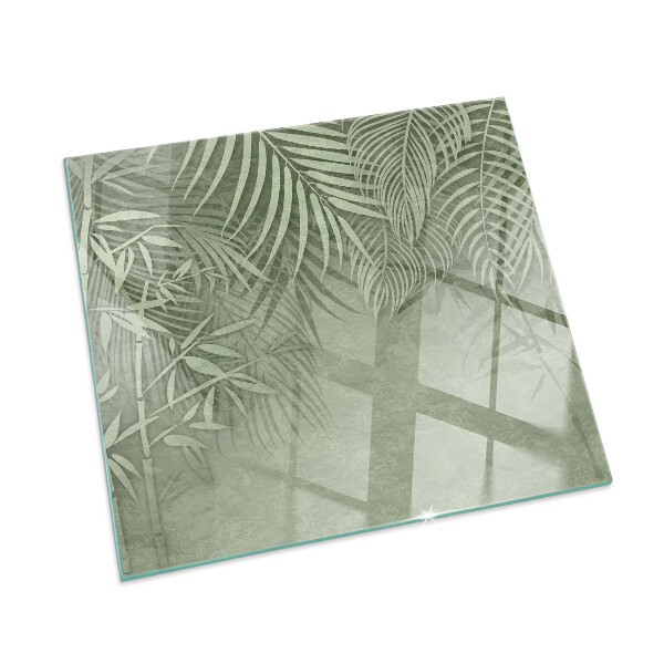 Plaque de sol en verre pour poêle Arrière-plan avec des feuilles tropicales