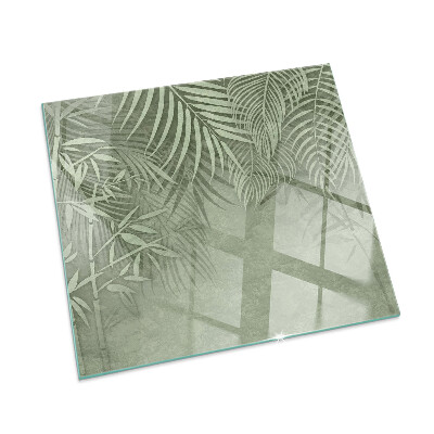 Plaque de sol en verre pour poêle Arrière-plan avec des feuilles tropicales