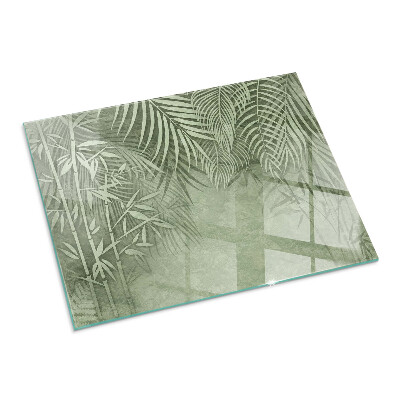 Plaque de sol en verre pour poêle Arrière-plan avec des feuilles tropicales