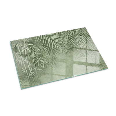 Plaque de sol en verre pour poêle Arrière-plan avec des feuilles tropicales