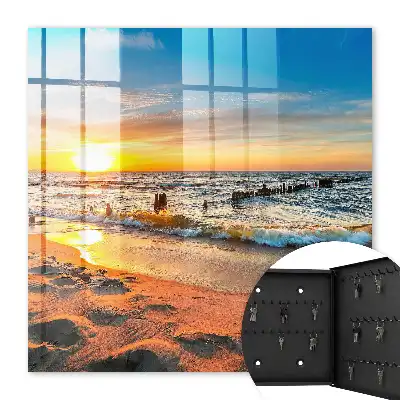 Tableau représentant un coucher de soleil sur la mer avec une plage
