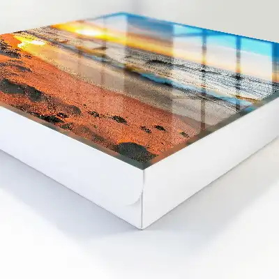 Tableau représentant un coucher de soleil sur la mer avec une plage