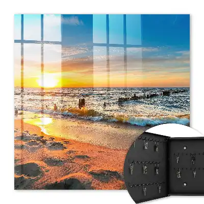 Tableau représentant un coucher de soleil sur la mer avec une plage
