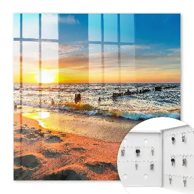 Tableau représentant un coucher de soleil sur la mer avec une plage