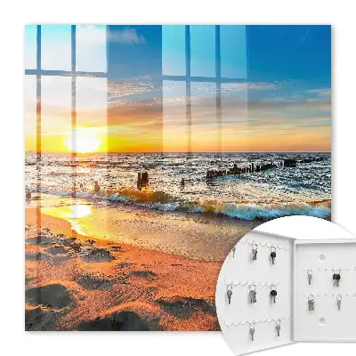 Tableau représentant un coucher de soleil sur la mer avec une plage