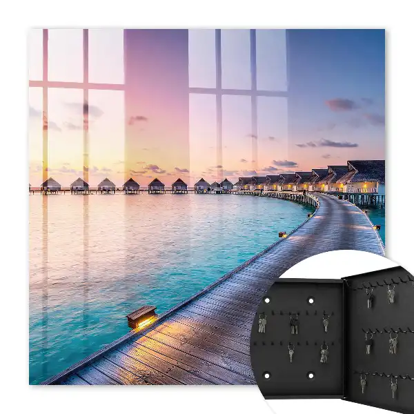 Tableau représentant un coucher de soleil paisible avec des maisons au bord de l'eau