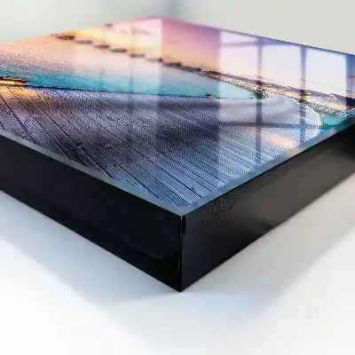 Tableau représentant un coucher de soleil paisible avec des maisons au bord de l'eau