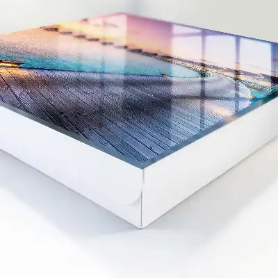 Tableau représentant un coucher de soleil paisible avec des maisons au bord de l'eau
