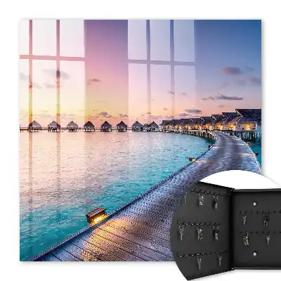 Tableau représentant un coucher de soleil paisible avec des maisons au bord de l'eau