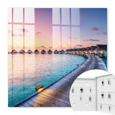 Tableau représentant un coucher de soleil paisible avec des maisons au bord de l'eau
