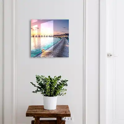 Tableau représentant un coucher de soleil paisible avec des maisons au bord de l'eau