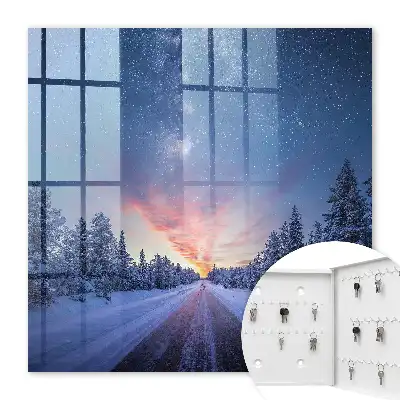 Des étoiles au-dessus de la route dans la forêt hivernale