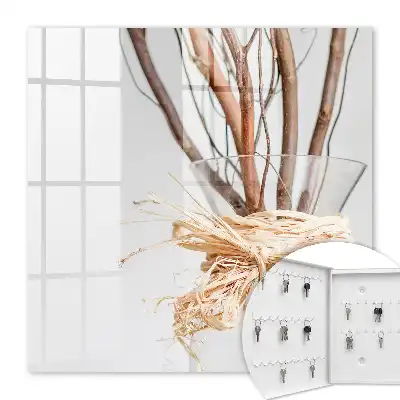 Branches décoratives dans un vase avec ficelle beige
